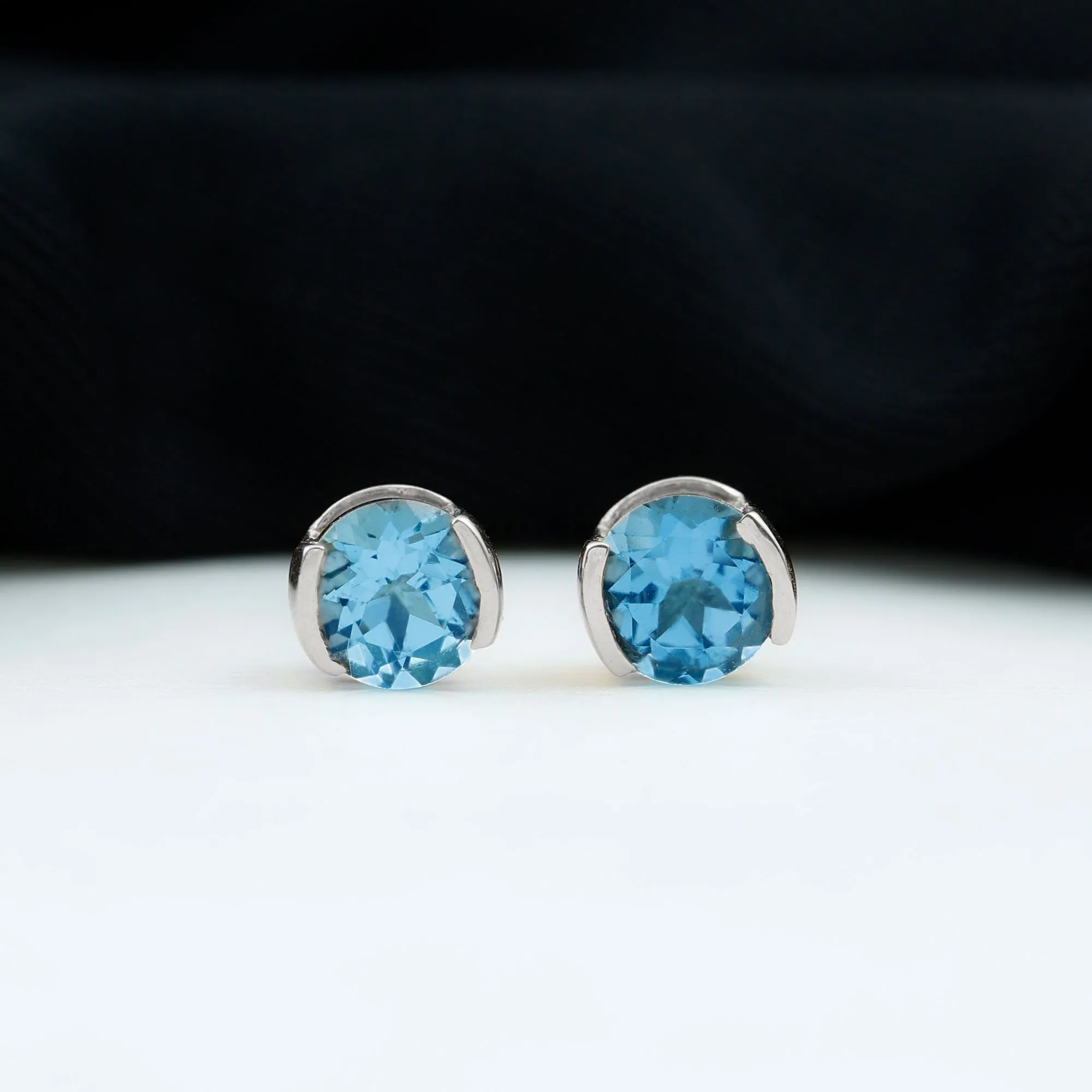 Swiss Blue Topaz Solitaire Stud Earrings in Half Bezel Setting